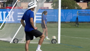 Nate Lie stands in front of a soccer net.