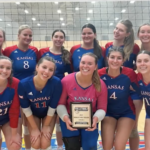 The KU Club Volleyball B team poses for a photo holding the award for 2025 Women’s west region division 2 champions.