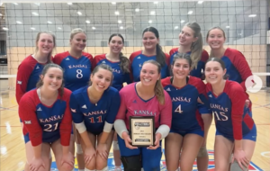 The KU Club Volleyball B team poses for a photo holding the award for 2025 Women’s west region division 2 champions.