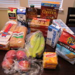 Groceries laid out on a kitchen table.