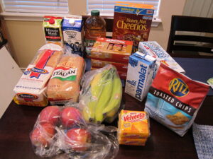 Groceries laid out on a kitchen table.