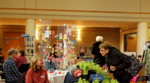 A vendor speaks with a customer at the Sip and Shop event