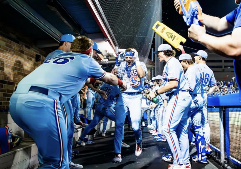 a group of people celebrate in a dugout
