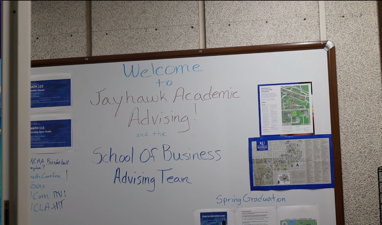 A white board reads "Welcome to Jayhawk Academic Advising"