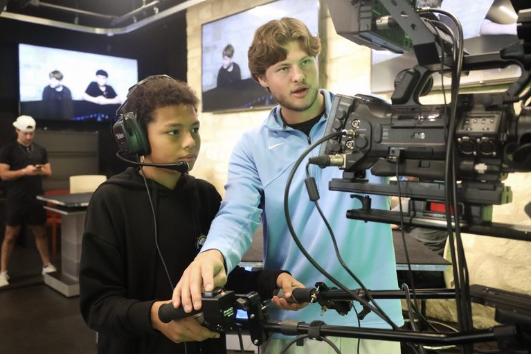Lawrence middle schoolers visit the KUJH studio to learn about broadcast journalism